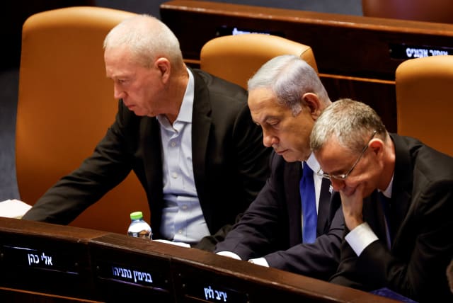  Prime Minister Benjamin Netanyahu sits between Justice Minister Yariv Levin and Defense Minister Yoav Gallant at the Knesset plenum in Jerusalem July 24, 2023 (photo credit: REUTERS/AMIR COHEN)