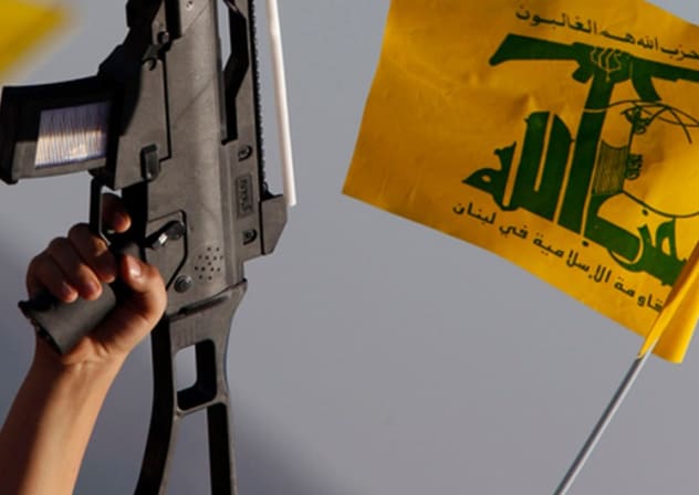 Lebanese child holds up plastic toy during pro-Hezbollah rally