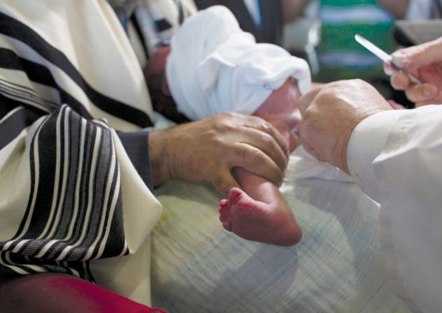 A ‘MOHEL’ holds a scalpel as he performs a circumcision