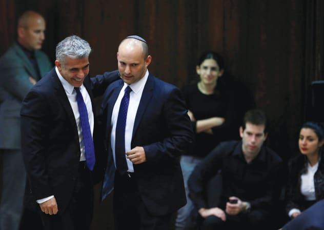 YAIR LAPID (left) and Naftali Bennett share a smile at the Knesset in 2013.