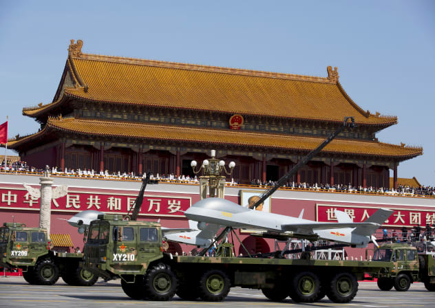  Military vehicles carrying Wing Loong, a Chinese-made medium altitude long endurance unmanned aerial vehicle, travel past Tiananmen Gate during a military parade to commemorate the 70th anniversary of the end of World War II in Beijing