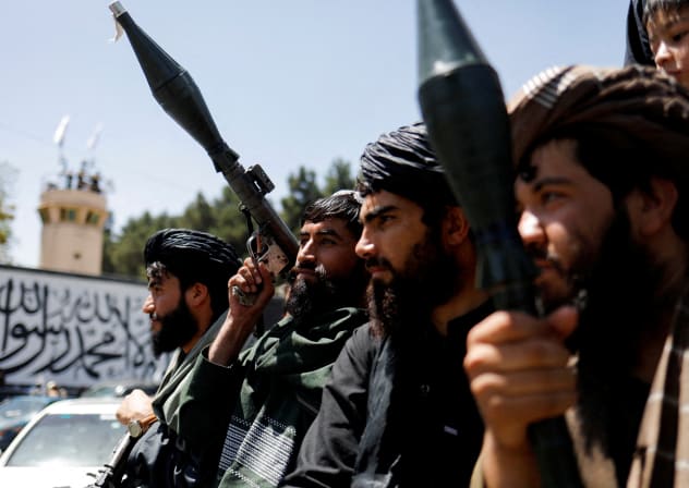  Taliban soldiers celebrate on the second anniversary of the fall of Kabul on a street near the US embassy in Kabul, Afghanistan, August 15, 2023