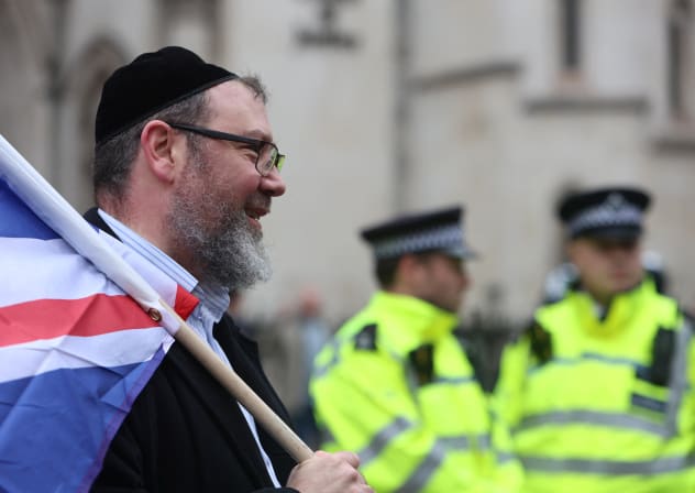  A man, wearing a kippah, holds the British flag at a march against antisemitism, after an increase in the UK, in London, Britain November 26, 2023. 