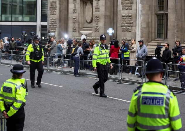  Police officers keep guard outside the Rolls Building of the High Court ahead of the appearance of Britain's Prince Harry in London, June 6, 2023.
