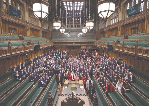  NEWLY ELECTED BRITISH MPs gather in the House of Commons Chamber for a group photo in London.