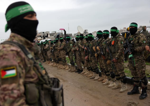 Hamas terrorists stand guard in Rafah, in the southern Gaza Strip, February 22, 2025