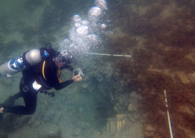  Marine archaeologist reviews underwater findings.