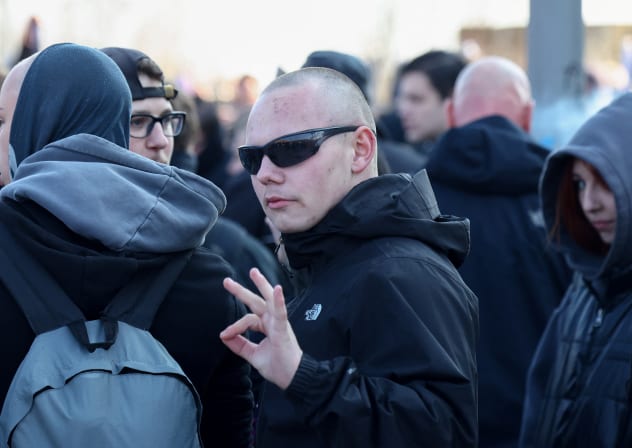  A demonstrator gestures, what is believed to symbolise "WP" for 'white power', at a right-wing protest at Friedrichshain district in Berlin, Germany, March 22, 2025. 