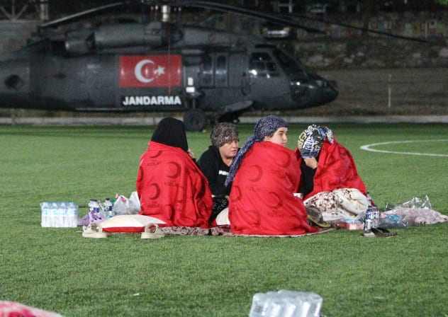 People spend the night at a stadium after an earthquake in Sindirgi in the western Balikesir province, Turkey, August 11, 2025.
