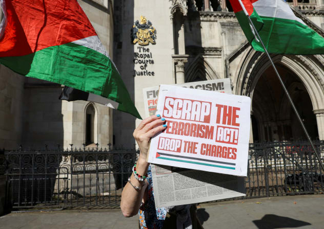 A person holds up a placard outside the Royal Courts of Justice, on the day judges decide whether the co-founder of Palestine Action can challenge the UK government's ban on the group, in London, Britain, September 25, 2025.