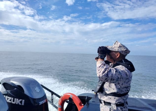 A staff member of the Malaysian Maritime Enforcement Agency searches for victims of a boat from Buthidaung, Myanmar, that sank near the Malaysia–Thailand border, during a search and rescue operation close to Langkawi, Malaysia November 9, 2025.