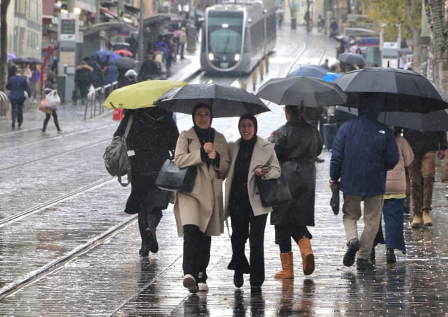 People walking in the rain on Jaffa Road, Jerusalem, December 28, 2025.