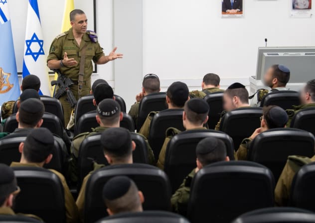 Maj.-Gen. Dado Bar Khalifa, head of the IDF’s Human Resources Department, addresses ultra-Orthodox recruits as they enlist in the military.