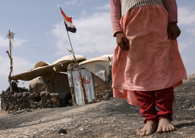 (ILLUSTRATIVE) A displaced Yemeni girl stands outside her shelter inside a displaced persons camp in Marib, Yemen, October 28, 2024.