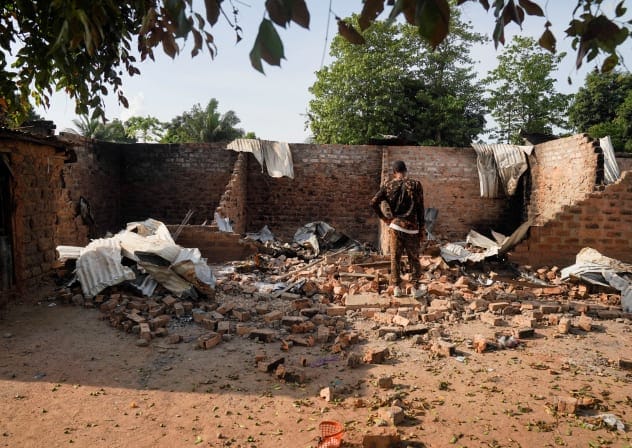  A man stands in front of a damaged and burnt house following a deadly gunmen attack in Yelwata, Benue State, Nigeria, June 16, 2025.