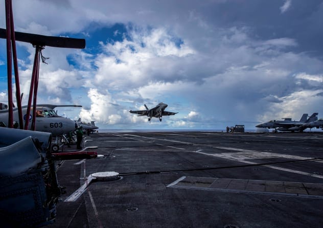 An F/A-18F Super Hornet, assigned to Strike Fighter Squadron (VFA) 41, prepares to make an arrested landing on the flight deck of the US Navy Nimitz-class aircraft carrier USS Abraham Lincoln in the Pacific Ocean August 10, 2024.
