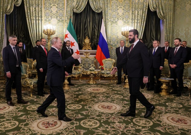 Syrian President Ahmed al-Sharaa (R) is welcomed by Russian President Vladimir Putin at the Kremlin in Moscow, on January 28. 