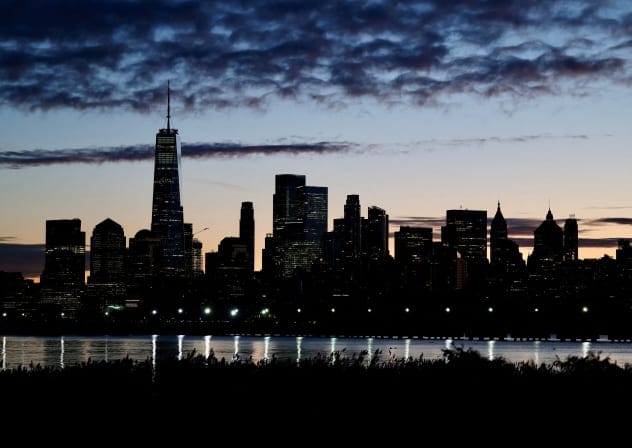 The skyline of Lower Manhattan is seen at dawn from across the Hudson River in New York City, US, October 18, 2025.