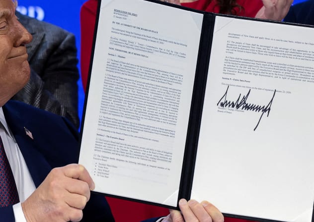 US President Donald Trump presents a signed resolution in a charter announcement for his Board of Peace initiative, alongside the 56th annual World Economic Forum, in Davos, Switzerland, on January 22.