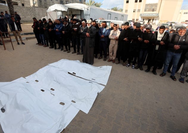 MOURNERS PRAY during the funeral of Palestinians in Gaza, who, according to medics, were killed by an Israeli strike, on Wednesday. While Hamas was flooding the world with unverified figures, Israel made no systematic effort to challenge them, the writers say. 