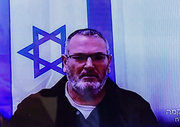 Bezalel Zini, accused of smuggling cigarettes into the Gaza Strip, is seen on a screen at the Beersheba District Court, February 5, 2026