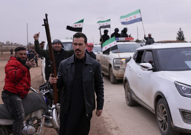 A man holds a gun, as internal security forces affiliated with the Syrian government prepare to enter the city of Qamishli in northeastern Syria, in Tel Brak, near al-Hasakah, Syria, February 3, 2026