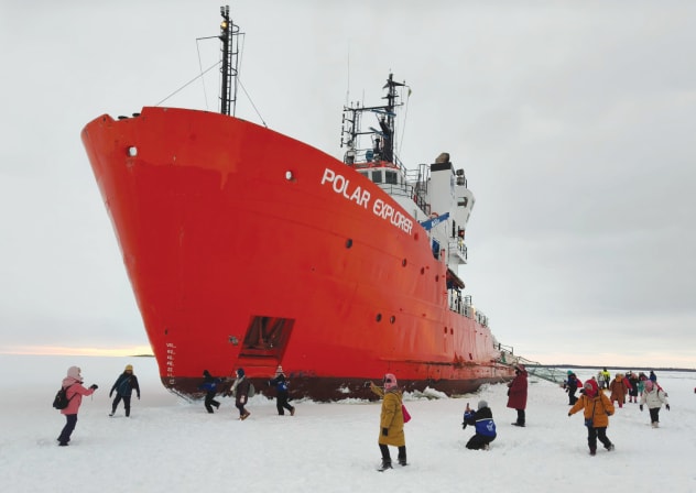 PASSENGERS OF the icebreaker ‘Polar Explorer’ walk across the frozen surface of the Bothnian Sea.