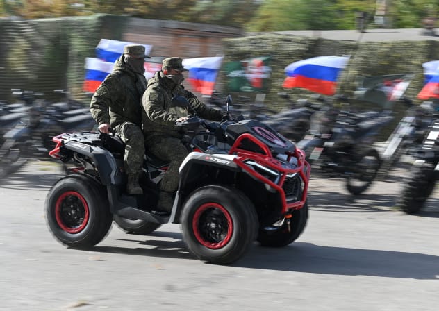 Russian service members attend a ceremony organized by the People's Front political movement to hand over new motocross bikes, quad bikes and unmanned aerial vehicles to Russia's army for use in the ongoing military conflict against Ukraine, in Rostov-on-Don, Russia, October 3, 2025. 