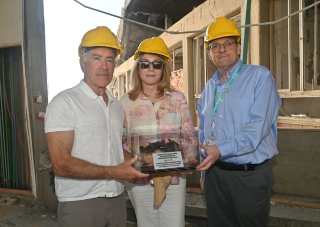 Sylvan Adams receives Iranian missile fragment from Soroka CEO Prof Shlomi Codish.