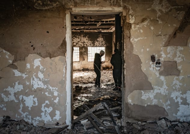 PEOPLE STAND inside a destroyed home in Sweida, Syria, that had been targeted in a massacre of Druze villages in the area by Syrian forces.