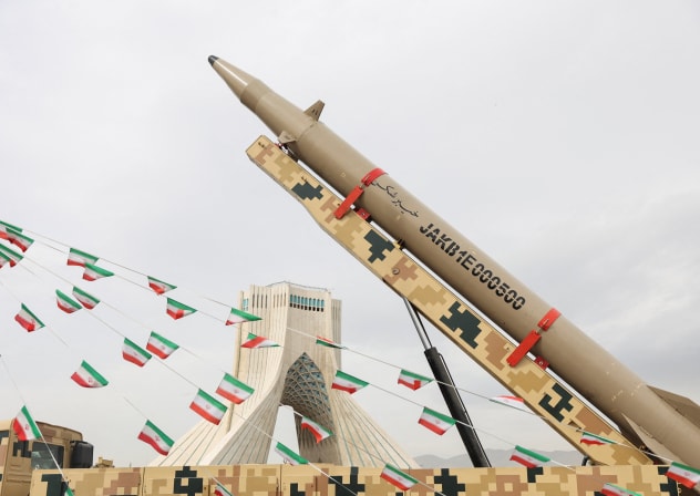 Bunting of Iranian flags next to a missile on display during the 47th anniversary of the Islamic Revolution in Tehran, Iran February 11, 2026.