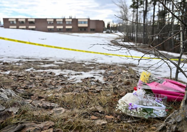 Flowers lie on the ground near the site of a mass shooting at a high school, in the town of Tumber Ridge, British Columbia, Canada February 11, 2026.