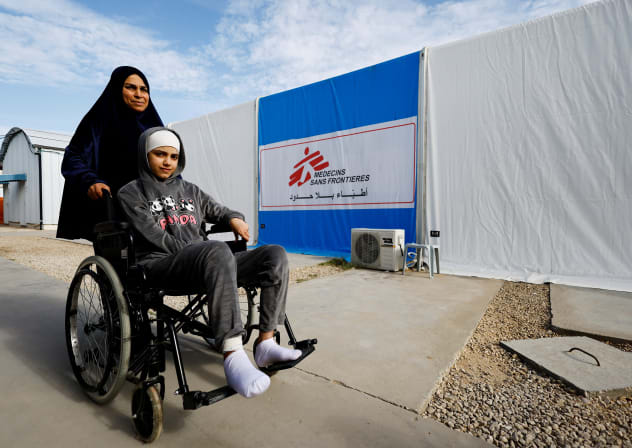 A Palestinian woman helps a burn victim, Maria Abu Aawad, at a Doctors Without Borders (MSF) hospital, amid severe shortages of medical equipment, medicines and essential materials needed for burn treatment, in Zawaida, in the central Gaza Strip, January 26, 2026.