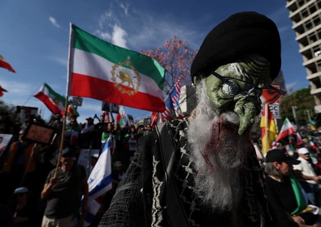 Placards are seen during a march in support of the people of Iran by members of the American-Iranian community in in Los Angeles on February 14, 2026.