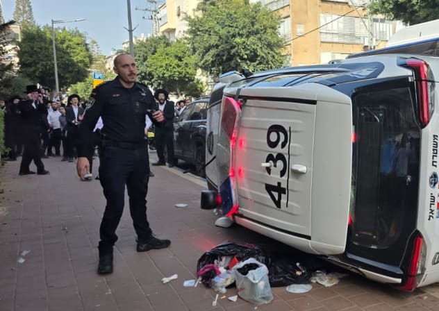 Haredi (ultra-Orthodox) mob flips police car while chasing female soldiers in Bnei Brak, February 15, 2026.