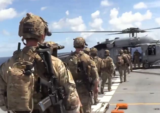 US troops are seen before boarding an oil tanker breaching Washington's blockade on sanctioned vessels traveling to or from Venezuela, February 15, 2026.