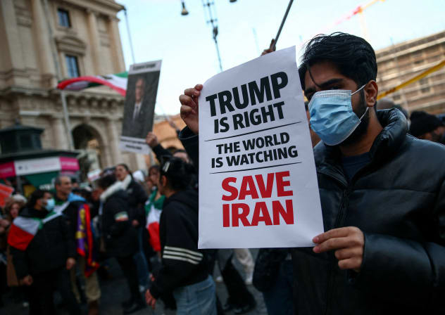 A man shows a sign mentioning US President Donald Trump during a rally in support of nationwide protests in Iran, in Rome, Italy, January 13, 2026. 