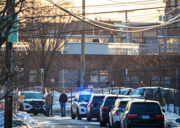 Police stand outside the perimeter they created around the Dennis M Lynch Arena where a shooting occurred earlier today in Pawtucket, Rhode Island, on February 16, 2026. At least two people were killed and three wounded in a shooting at an ice rink in the northeastern US town of Pawtucket on Monday.