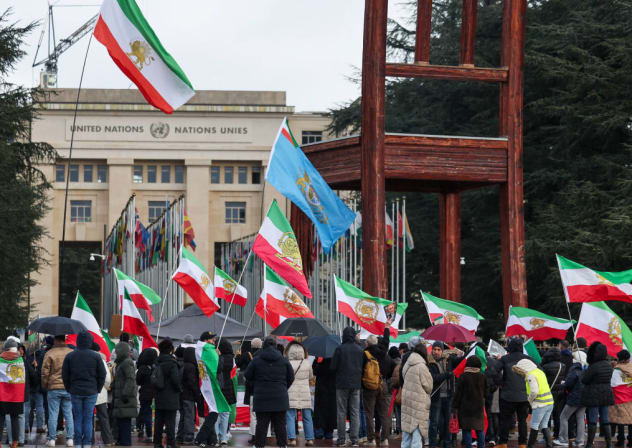 La gente lleva banderas nacionales «León y Sol» anteriores a la Revolución Iraní mientras se reúnen cerca de la oficina de las Naciones Unidas, mientras se celebra la segunda ronda de negociaciones nucleares entre Estados Unidos e Irán, en Ginebra, Suiza, el 17 de febrero de 2026