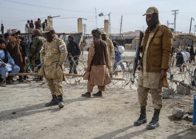 This photograph taken on December 29, 2025 shows Taliban security personnel standing guard near the zero-point border crossing between Afghanistan and Pakistan at the Spin Boldak district of Kandahar province.