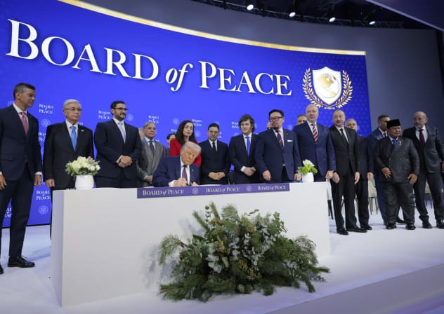 US President Donald Trump (C) holds up his signature on the founding charter as other world leaders look on during a signing ceremony for the “Board of Peace” at the World Economic Forum (WEF) on January 22, 2026 in Davos, Switzerland. 