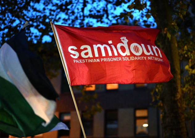 A photo shows a flag of the pro-Palestine organization 'Samidoun' during a "in solidarity with Gaza" demonstration in Duisburg, western Germany, on October 9, 2023.