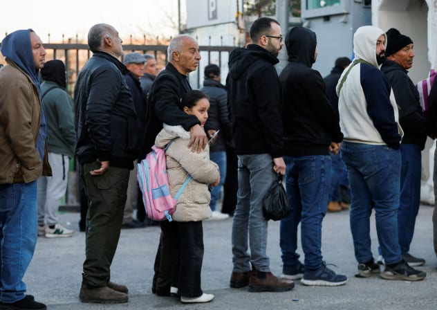 PALESTINIANS QUEUE at an Israeli checkpoint, as they make their way to the Temple Mount, in Jerusalem's Old City, to attend the first Friday prayers during the Muslim holy fasting month of Ramadan, in Bethlehem in the West Bank, February 20, 2026.