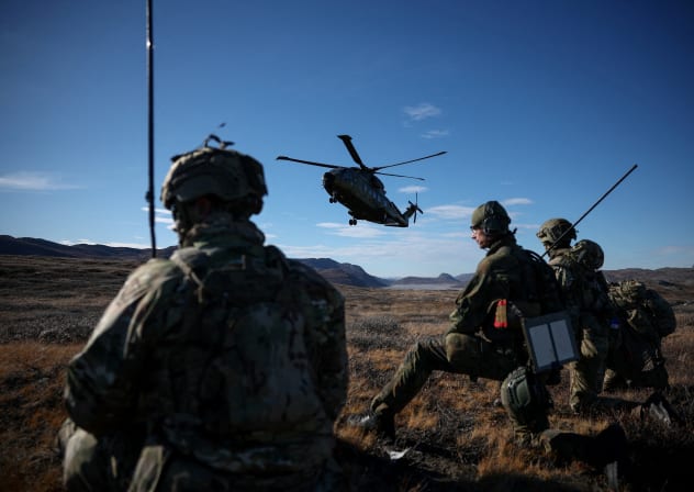 A DANISH helicopter flies near soldiers as Danish, Swedish and Norwegian home guard units together with Danish, German and French troops take part in joint military drills in Kangerlussuaq, Greenland, September 17, 2025.
