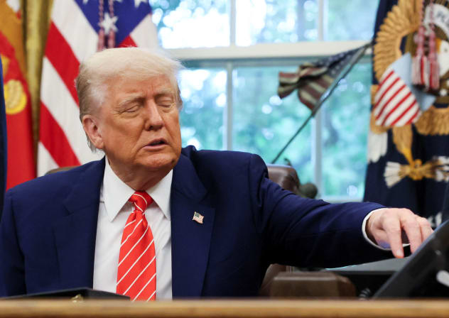 US President Donald Trump reaches for his phone as he makes an announcement in the Oval Office, White House, May 8, 2025; illustrative.