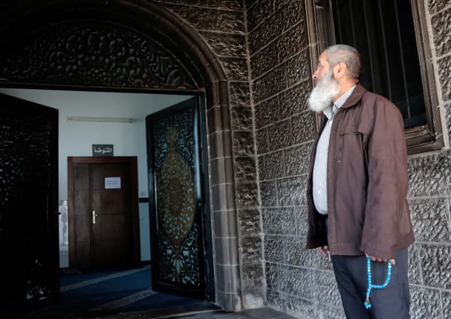 A Palestinian man, holding Misbaha prayer beads, inspects the debris at a mosque, which Palestinians say was damaged by Israeli settlers, in West Bank village of Surra, near Nablus in the Israeli-occupied West Bank, February 23, 2026.