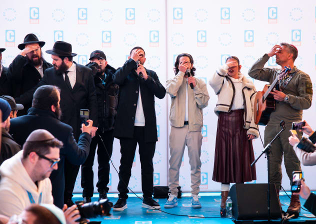 Freed Israeli hostages Matan Zangauker, Ilana Gritzewsky, and Segev Kalfon, recite the Shema prayer on stage in Times Square on February 21, 2026.