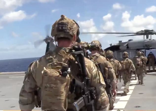 US forces prepare to board the vessel Veronica III, which tried to defy US President Donald Trump's quarantine, according to the US Department of Defense, in this screengrab obtained from a handout video released on February 15, 2026.