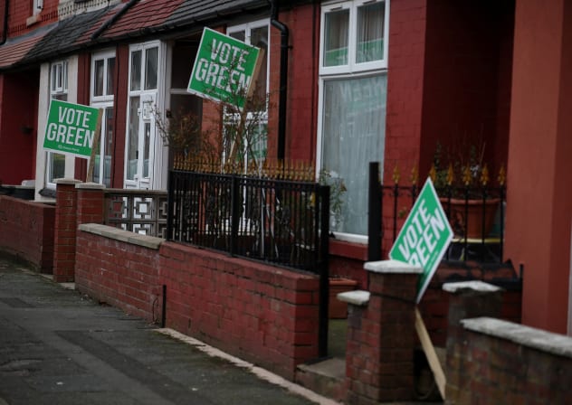 Signs in support of the Green Party stand outside houses in the constituency of Gorton and Denton ahead of a parliamentary by-election, in Manchester, Britain, February 18, 2026.