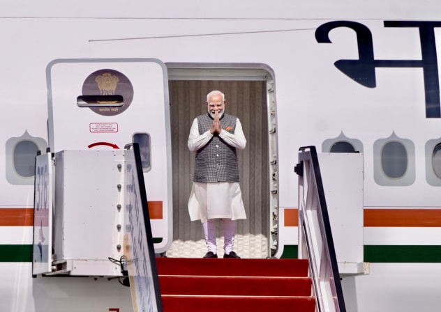 Indian Prime Minister Narendra Modi gestures while exiting his plane at Ben-Gurion Airport, February 25, 2026.